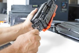 hands repairing laser toner cartridge